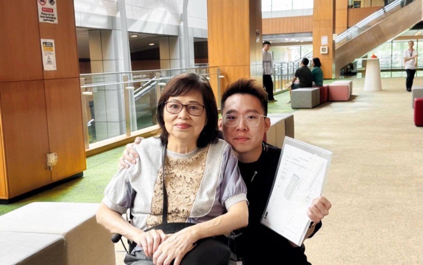 Nigel Aw with his mother on the day her HDB purchase completed